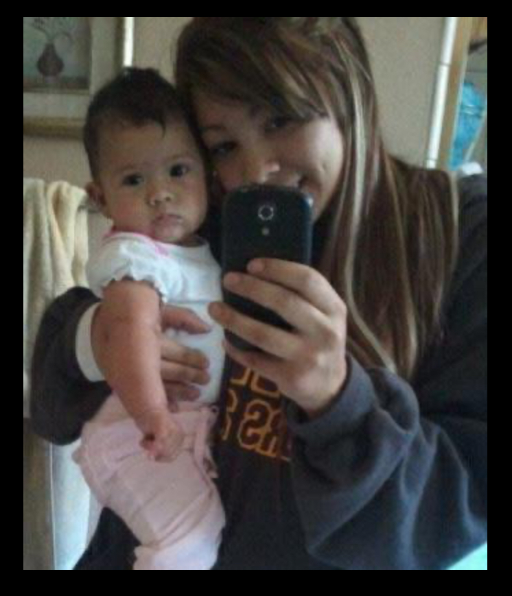 Founder as a young mother holding her baby